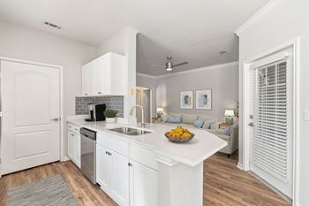A kitchen with white cabinets and a bowl of fruit on the counter at Sweetgrass Landing, Mount Pleasant, South Carolina